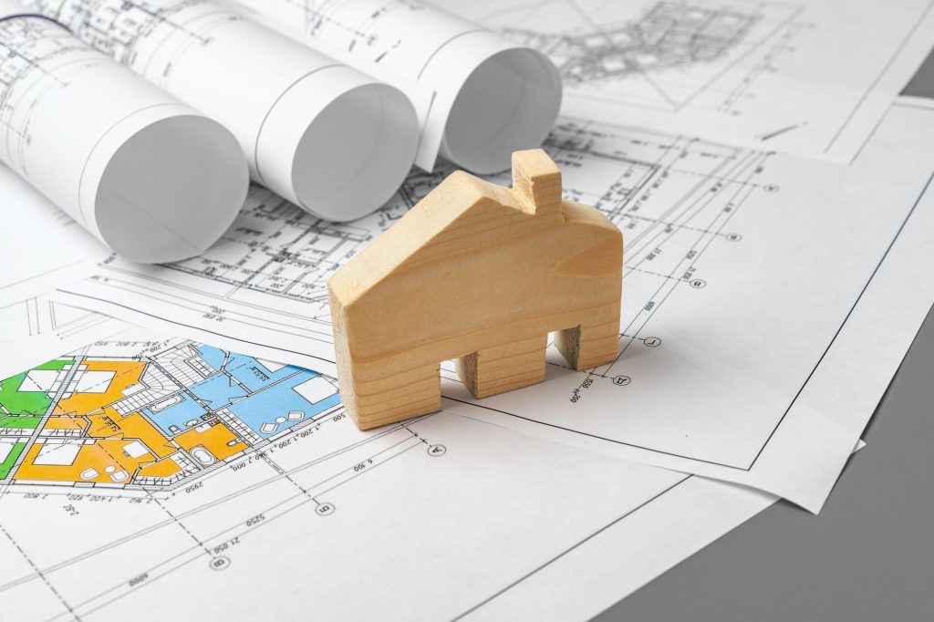 Architectural construction plans paper on table close up